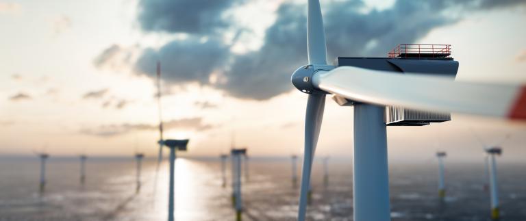 Offshore wind power and energy farm with many wind turbines on the ocean 1271332416 2672x1125